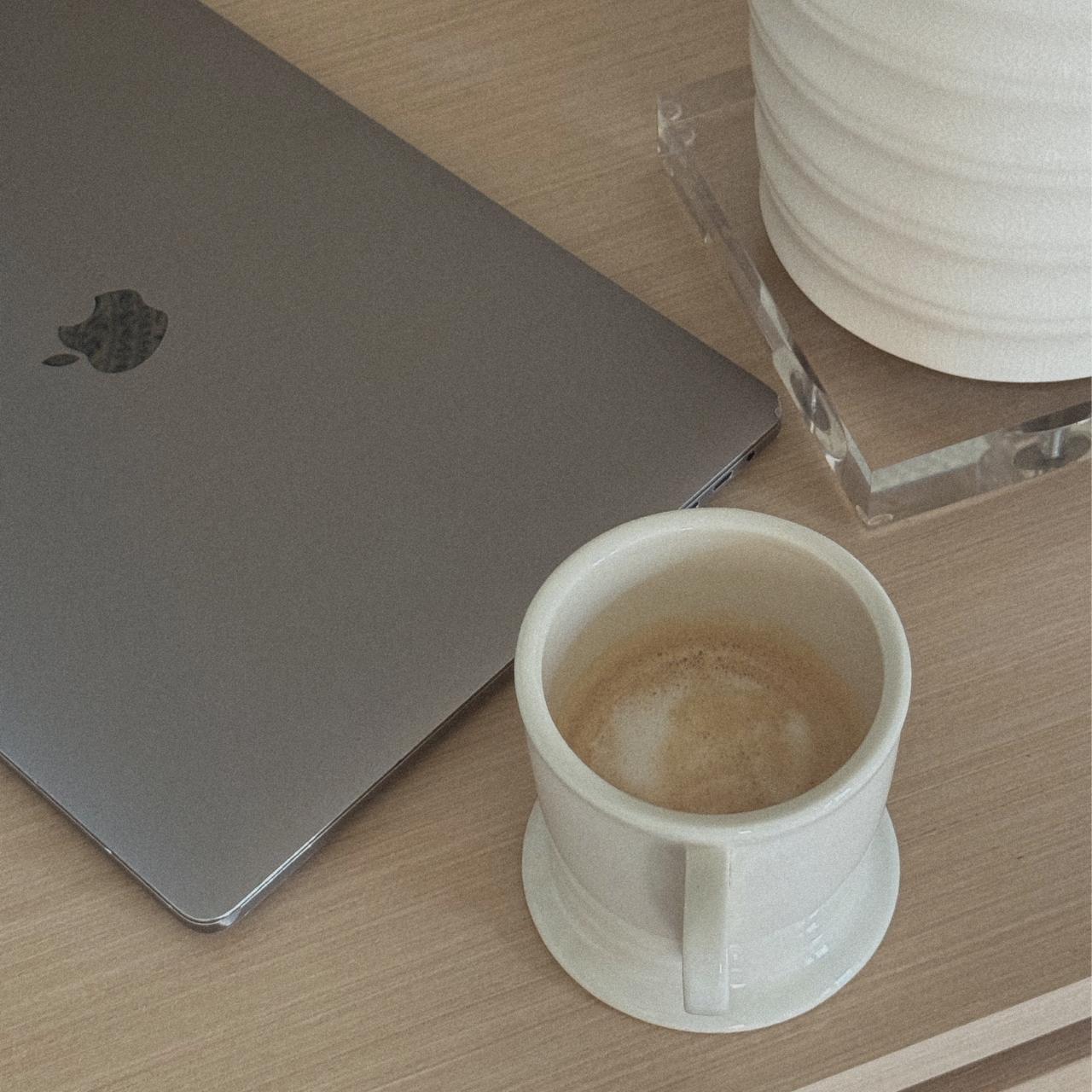 laptop cup of coffee and eyeglasses on wooden table